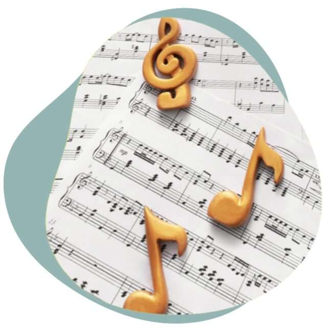 Golden treble clef and music notes resting on printed sheet music