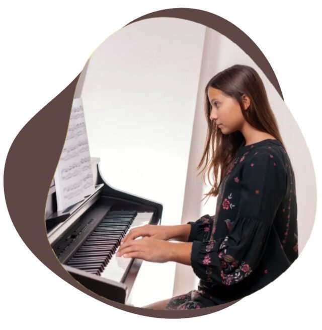 Girl sitting upright at a digital piano with relaxed hands on the keys